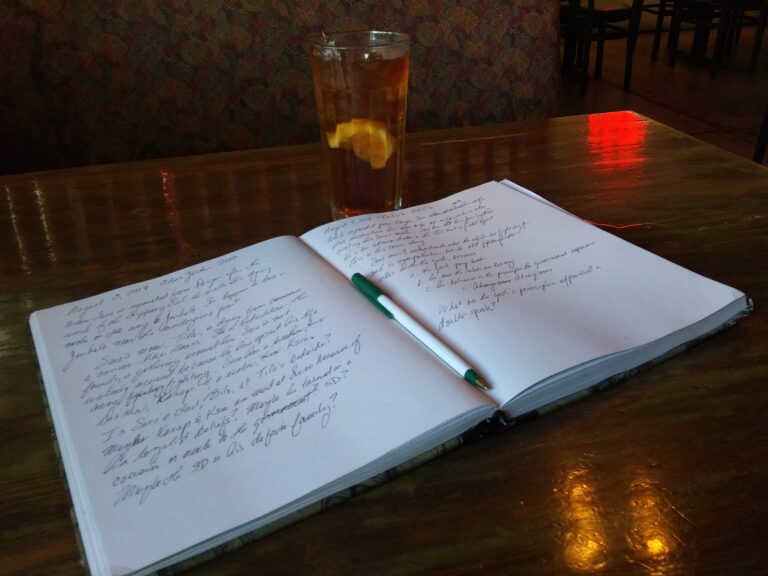 An open notebook with a pen resting on it
